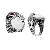 Handcrafted sterling silver ring with carved Bone Face, Garnet Quartz, and detailed Balinese floral design, unique artisan statement jewelry.